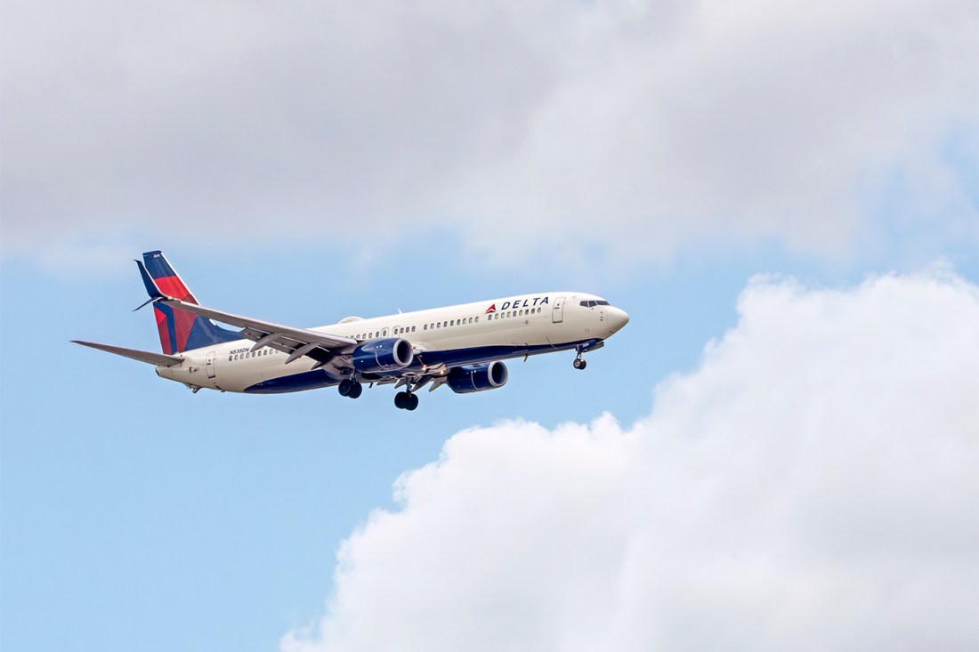A Delta plane flying through the sky.