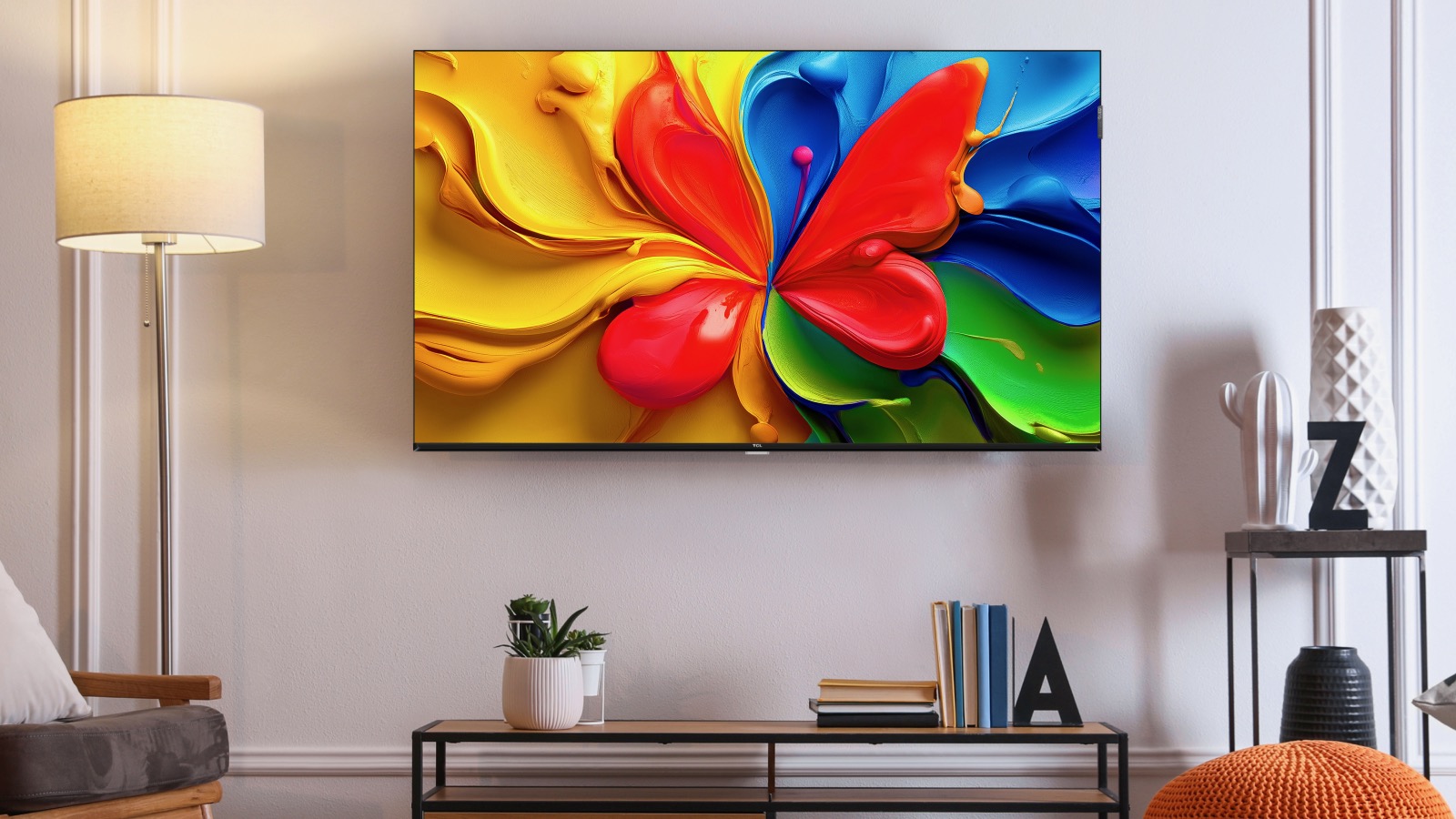 A TCL S4K TV wall-mounted in a modern lounge.