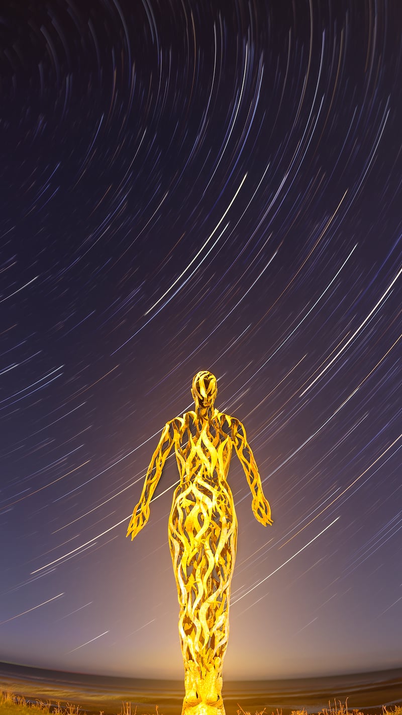 The Voyager, by Liam Reddall, Dublin, the winning image in Back on Earth – Landmark. 'I had seen the Voyager Statue by Linda Brunker while scouting locations online and knew it would make a captivating foreground subject. This bronze stature looks out over the coast to the sea, allowing for an uninterrupted view of the night sky. Lit by the surrounding streetlamps, it takes on a golden glow under long-exposure photography'