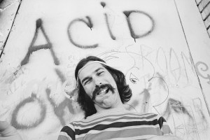 Mickey Hart of the rock and roll band "The Grateful Dead" poses for a portrait under graffiti that reads "Acid" on Portrero Hill in 1968 in San Francisco, California. (Photo by Malcolm Lubliner/Michael Ochs Archives/Getty Images)