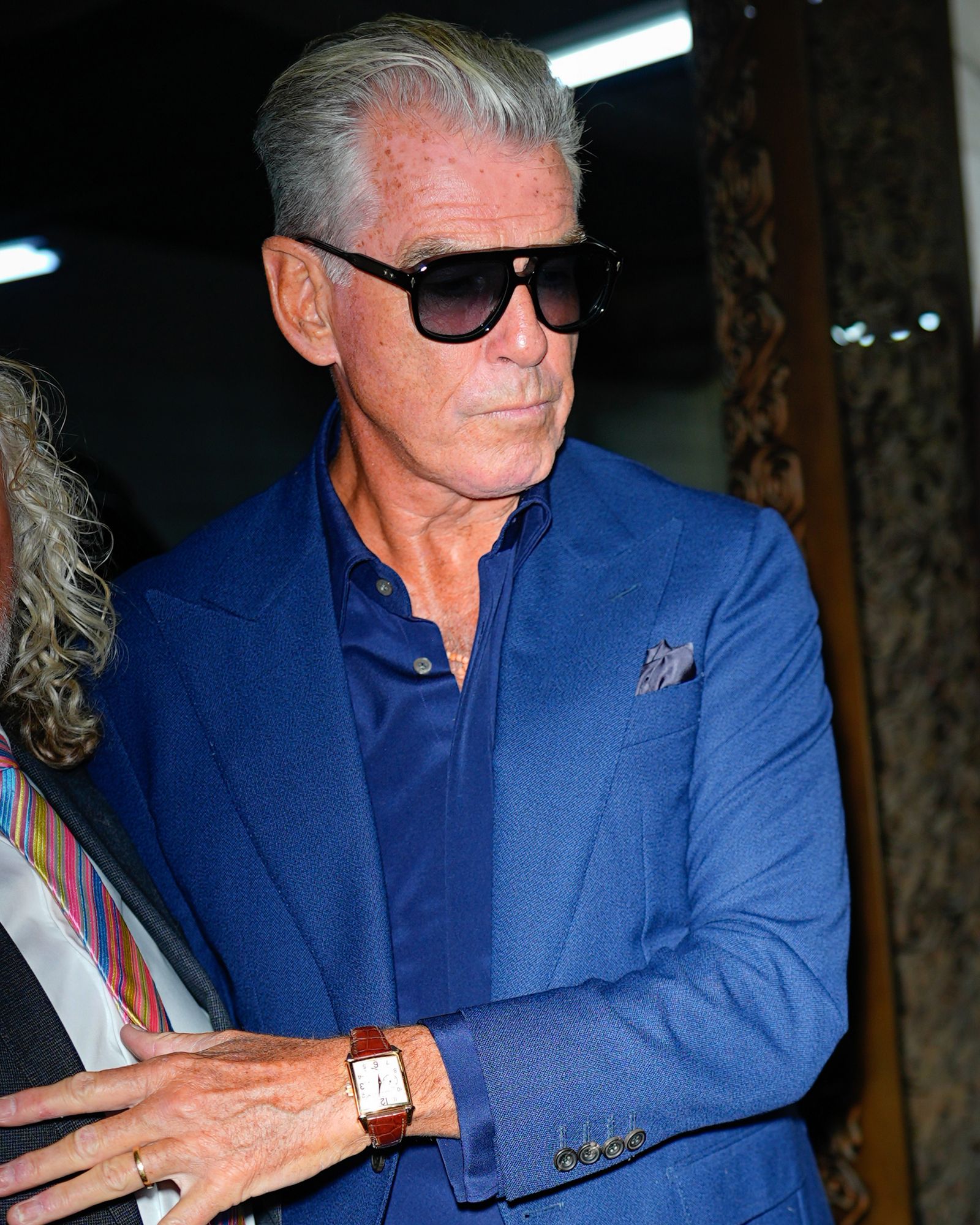 Image may contain Pierce Brosnan Wristwatch Accessories Glasses Adult Person Jewelry Ring Formal Wear and Tie
