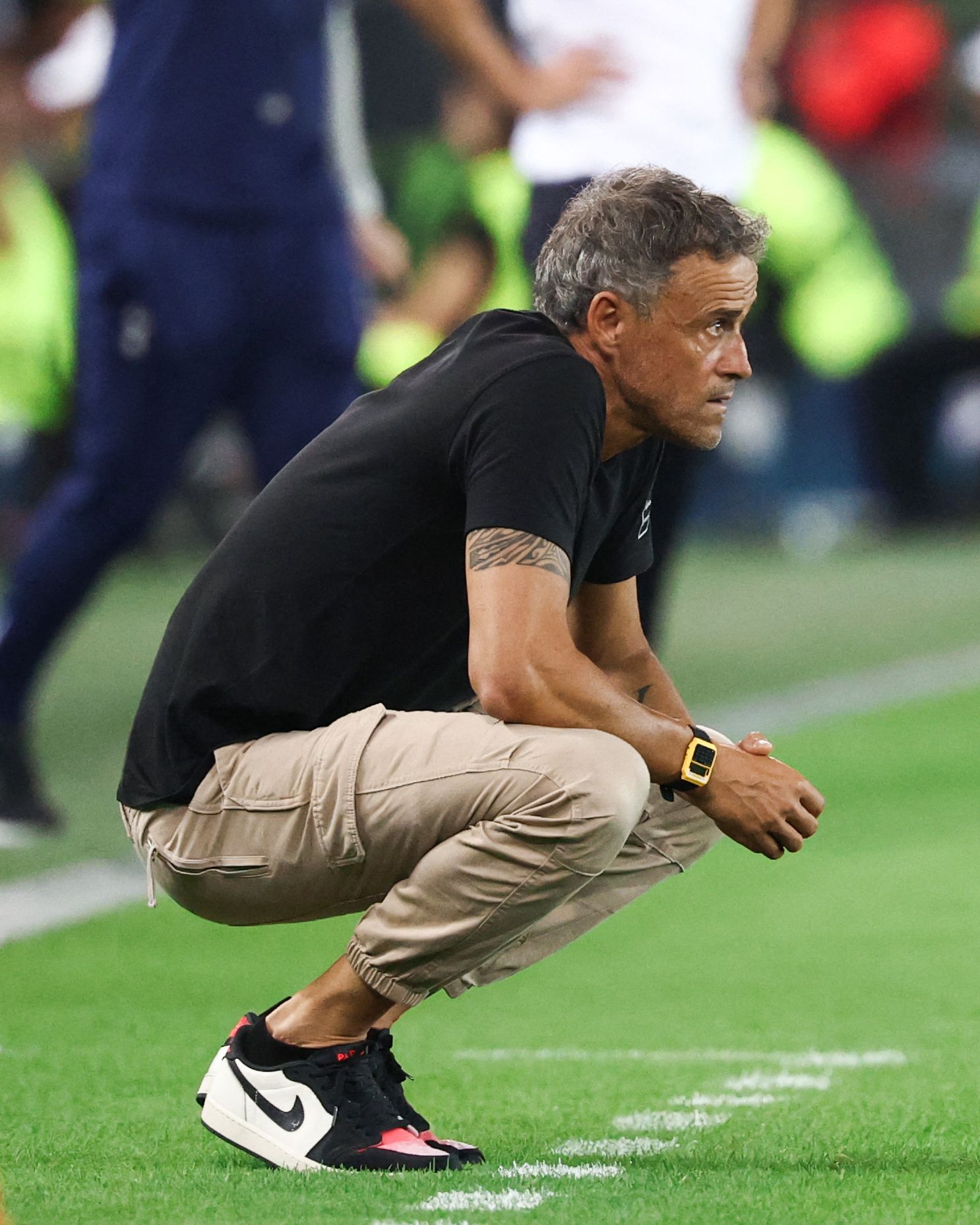 Image may contain Luis Enrique Wristwatch Clothing Footwear Shoe Adult Person Pain and Sneaker