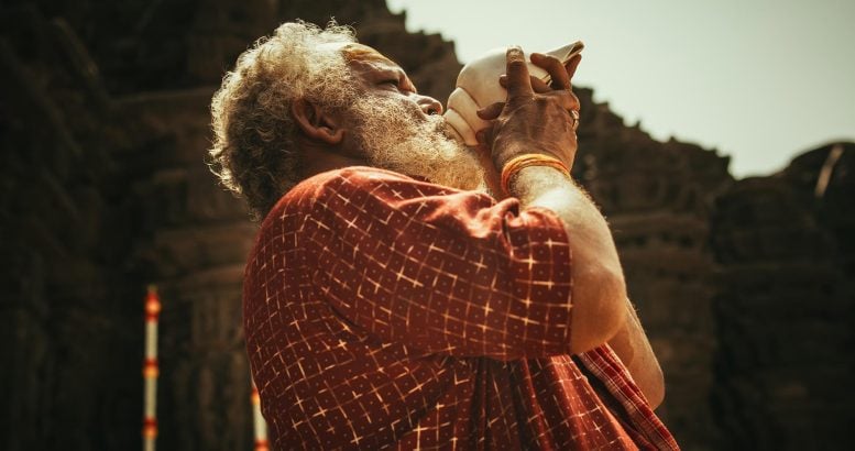 Indian Man Blowing Through Conch Shell