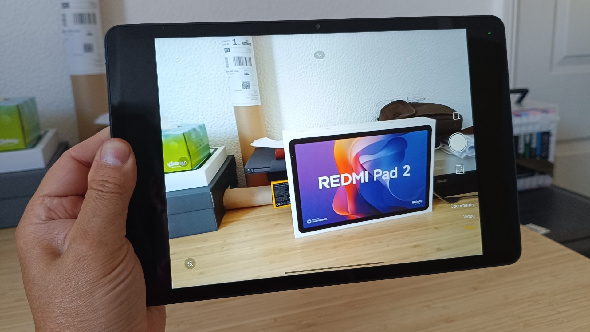 Remdi Pad 2 tablet being used to take a photo of its packaging