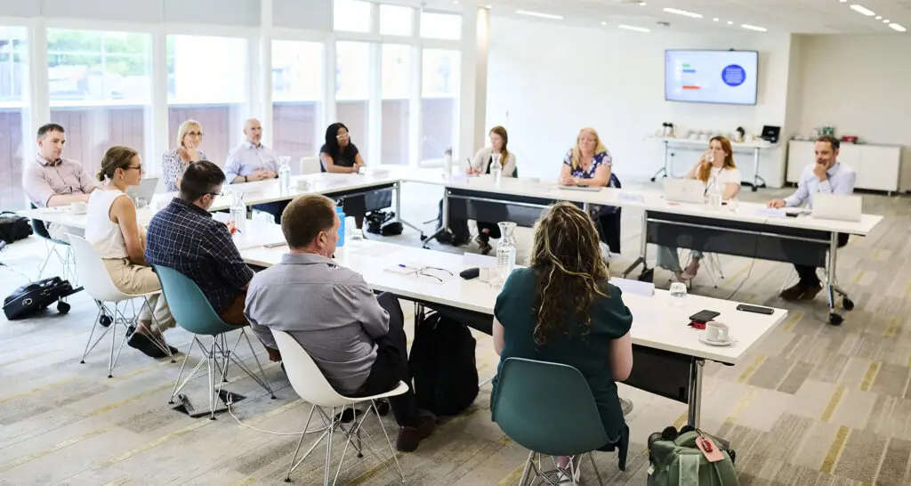 The roundtable panel members in discussion around a table at the RPS headquarters in Wapping, London