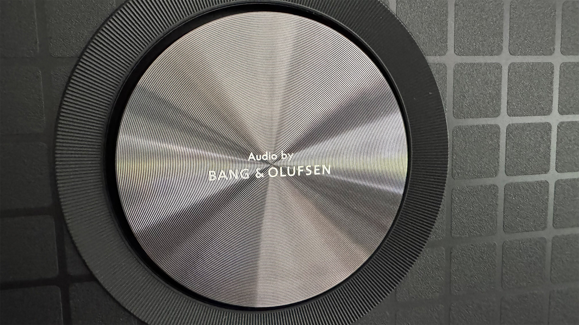 TCL 65C8K LCD TV close up on rear speaker with Audio by Bang & Olufsen logo