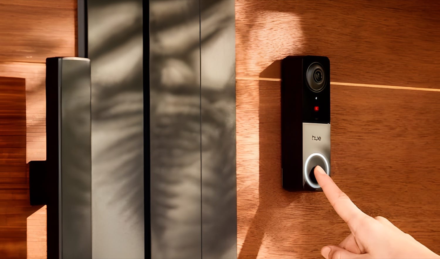 The first official picture of the new Hue Wired Doorbell shows a slim device with a prominent button surrounded by LEDs and the Hue logo beneath a camera.