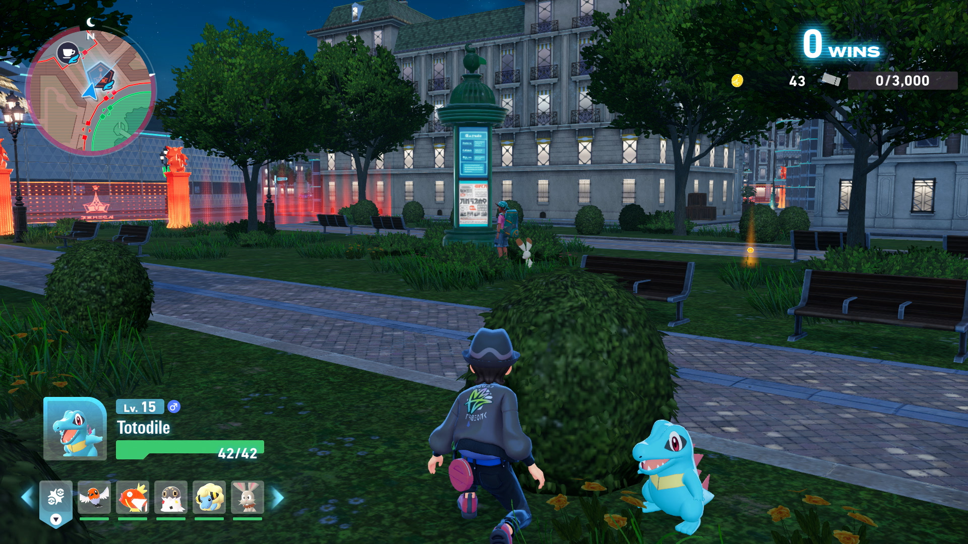 The player in Pokémon Legends: Z-A crouching behind a bush with their Totodile, waiting to ambush an opponent up ahead.