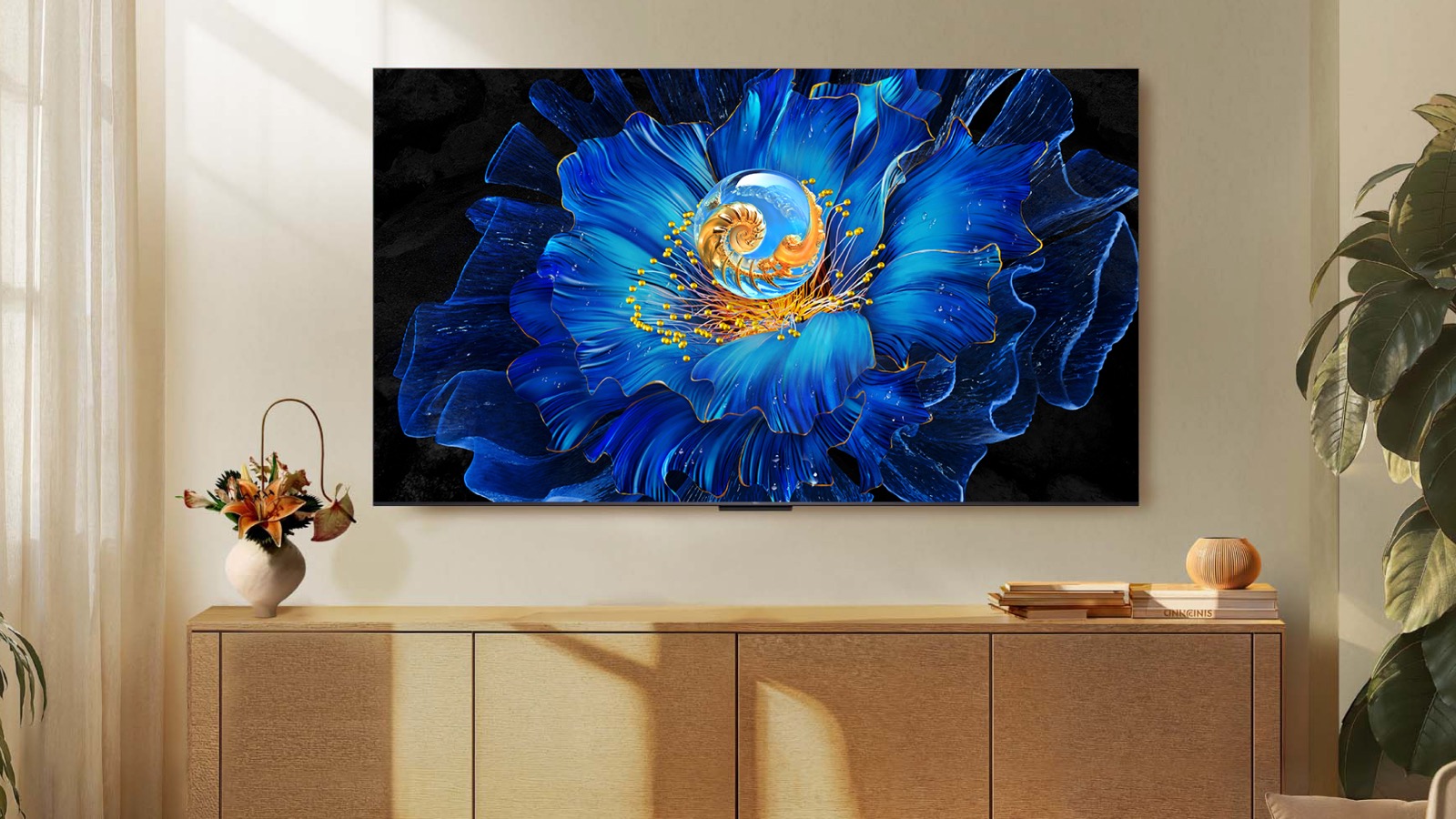 A TCL C6KS TV wall-mounted above a side unit in a light, airy room.