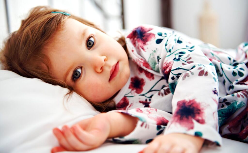 Iron Deficiency Alert: Are You and Your Kids Getting Enough. Young girl laying in bed not sleeping