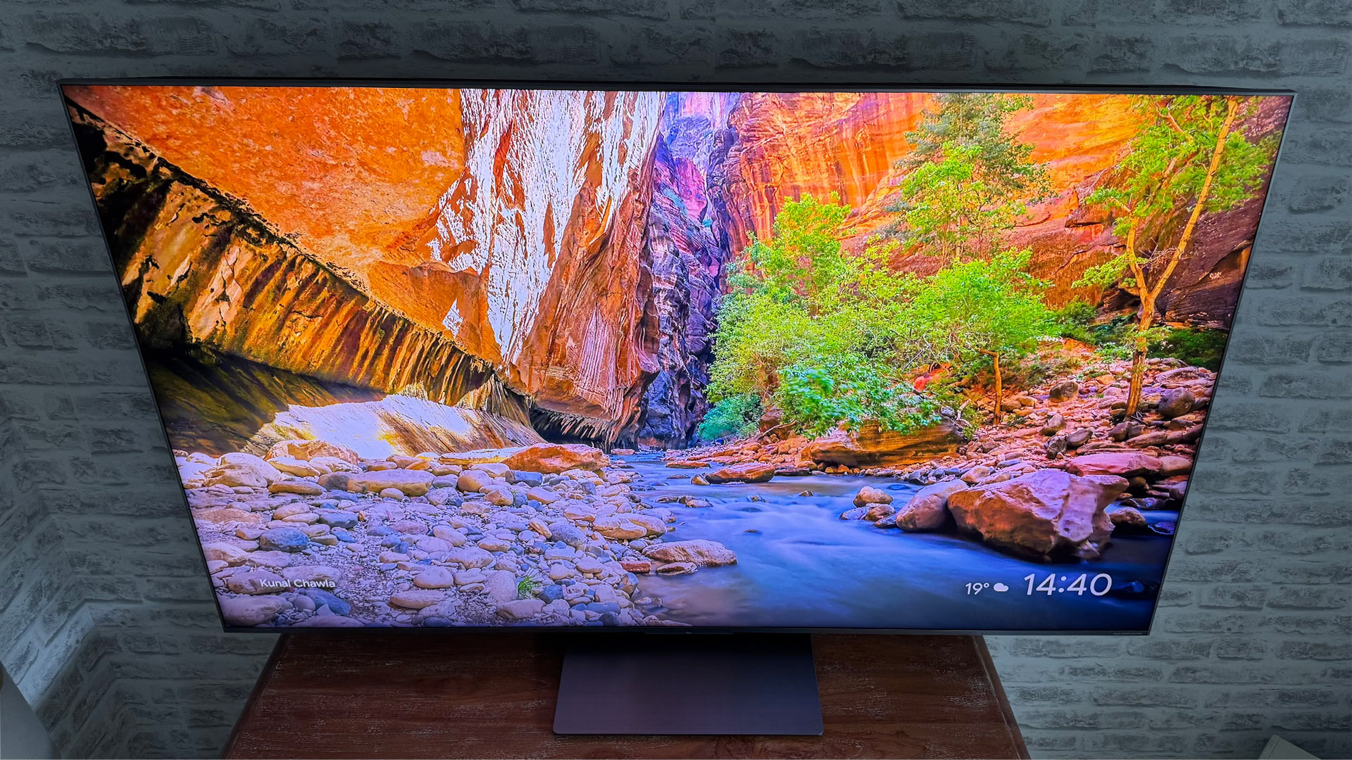 TCL 65C8K LCD TV slight angle downwards, on screen is stream and trees