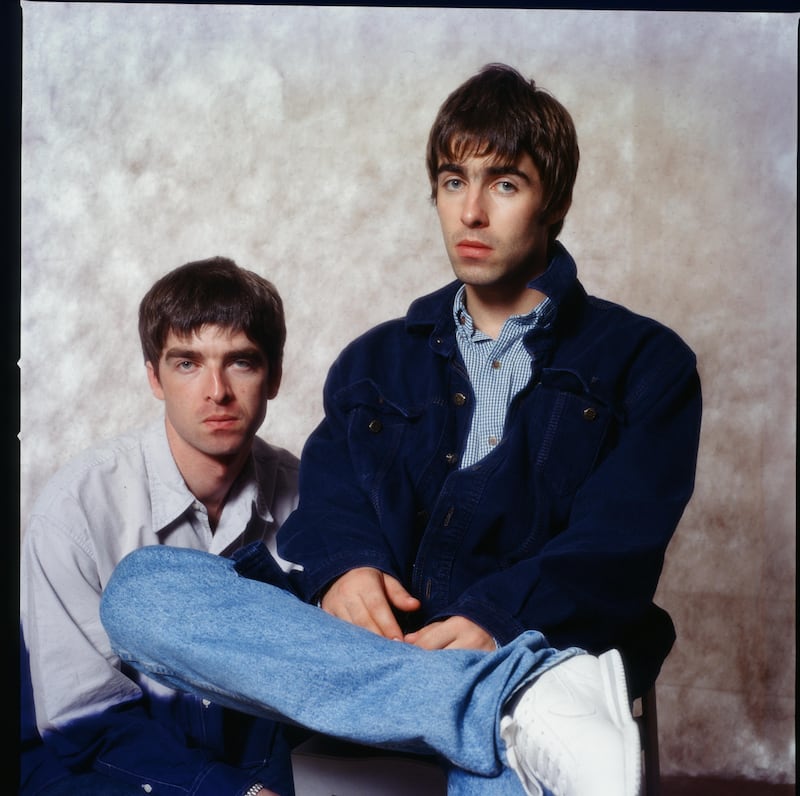 Noel Gallagher and Liam Gallagher at a photoshoot in a hotel in Tokyo, September 1994. Photograph: Koh Hasebe/ Shinko Music/ Getty Images
