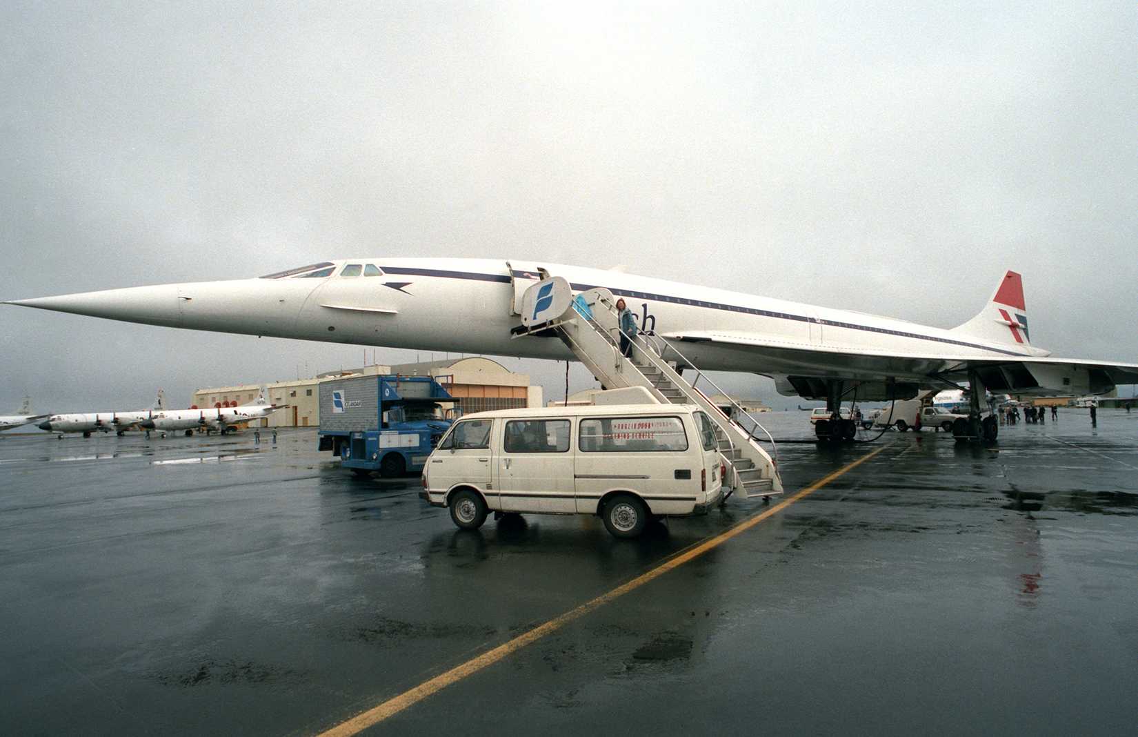 A left front view of a British Airways Concorde aircraft parked on the flight line at NAS Keflavik. The aircraft is on an around-the-world test flight