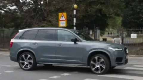 BBC An SUV driving over a zebra crossing in London