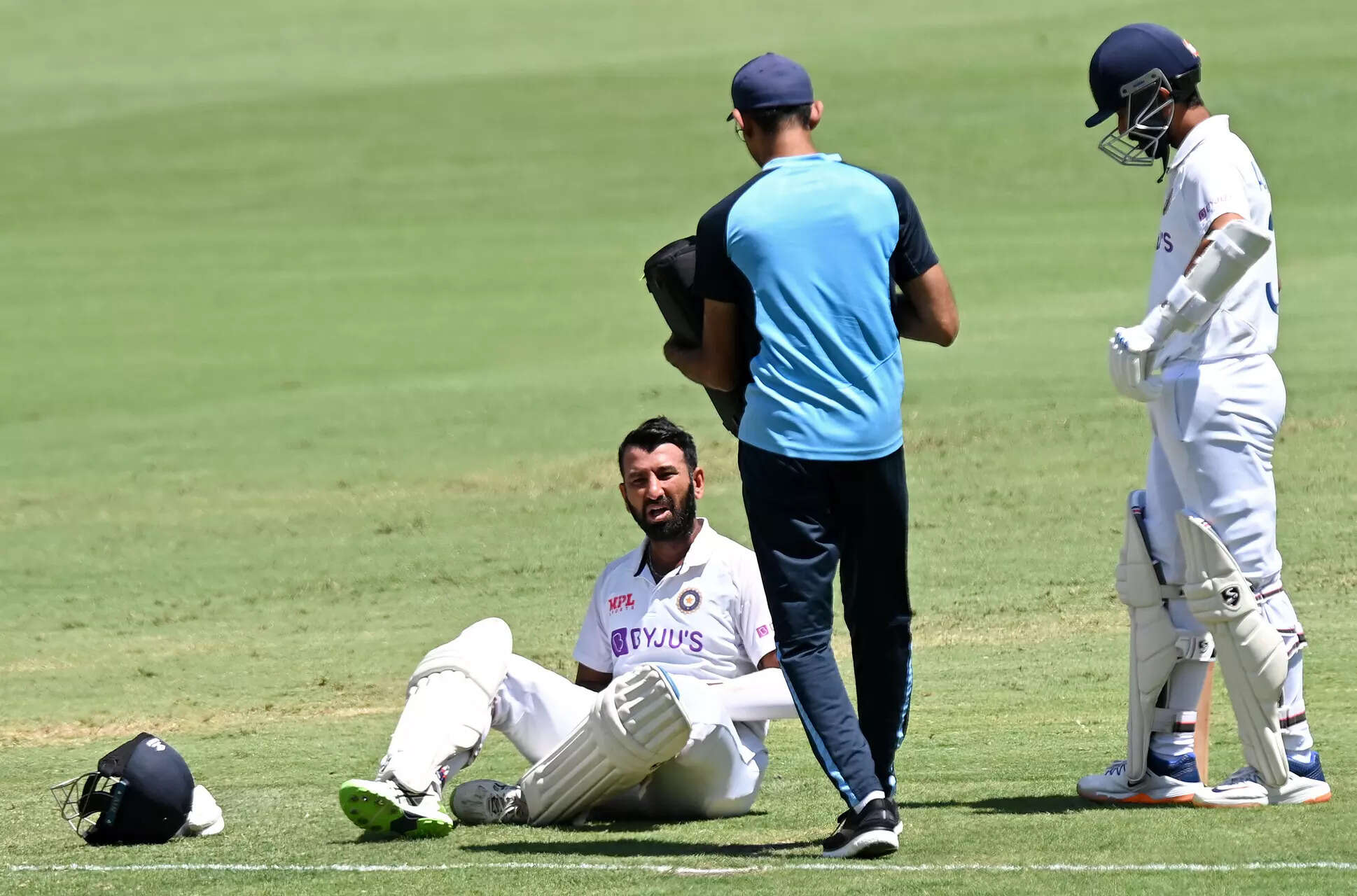 Cheteshwar Pujara is seen to by a medic after being struck by the ball during day five of the 4th Test Match in the series between Australia and India at The Gabba on January 19, 2021 in Brisbane, Australia. (Photo by Bradley Kanaris/Getty Images) Australia v India: 4th Test: Day 5