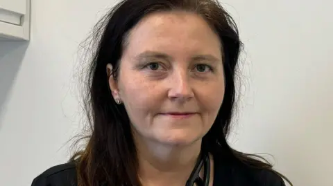 BBC Dr Liz Donald is looking into the camera with a smile. She is wearing a black clinical top.