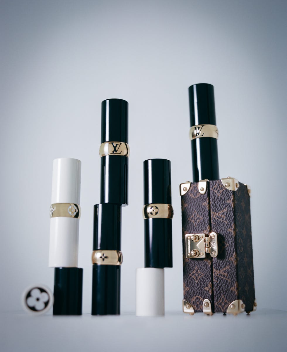 Stacked lipsticks and a designer case.