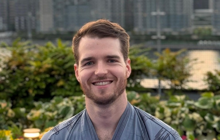 Portrait of Nicholas McGreivy taken outside.
