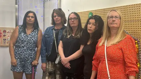 BBC Five mothers standing in a play centre looking a the camera
