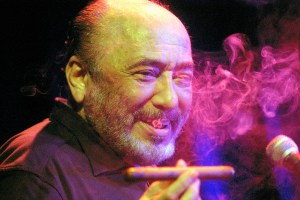 AMSTERDAM, NETHERLANDS - MARCH 19: Eddie Palmieri smokes a cigar while performing on stage at Paradiso on March 19 2004 in Amsterdam, Netherlands. (Photo by Frans Schellekens/Redferns)