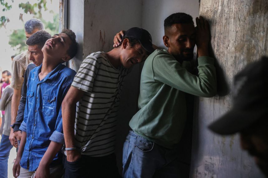 Palestinians mourn outside the Al-Shifa Hospital morgue, where the bodies of people killed while seeking aid the previous day were brought, in Gaza City on July 31.