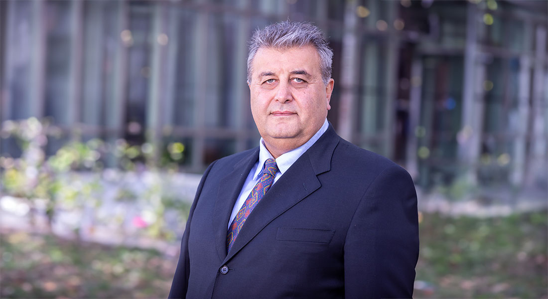 Dr. Ramin Shiekhattar in dark suit and tie