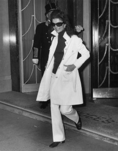 Jackie Onassis (1929 - 1994), widow of American President John F Kennedy and wife of Greek born Argentinian ship owner Aristotle Onassis, leaving Claridges Hotel in London. She is wearing a safari-style jacket over flared hipster trousers and a polo neck jersey. (Photo by Ted West/Getty Images)
