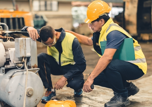 worker looking fatigued, being comforted by another worker