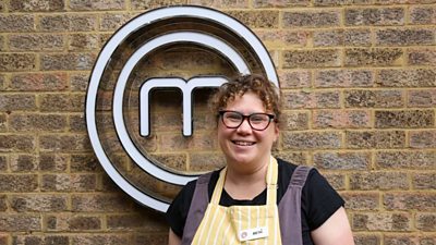 A portrait image of a contestant stood against an exposed brick wall, with the MasterChef logo behind her.