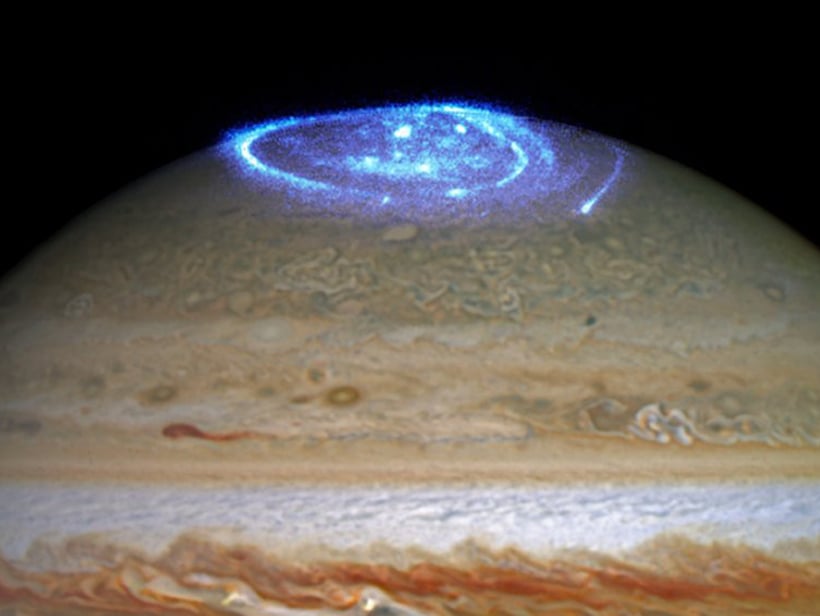 Auroras shine bright blue over Jupiter (Credit : NASA/ESA)
