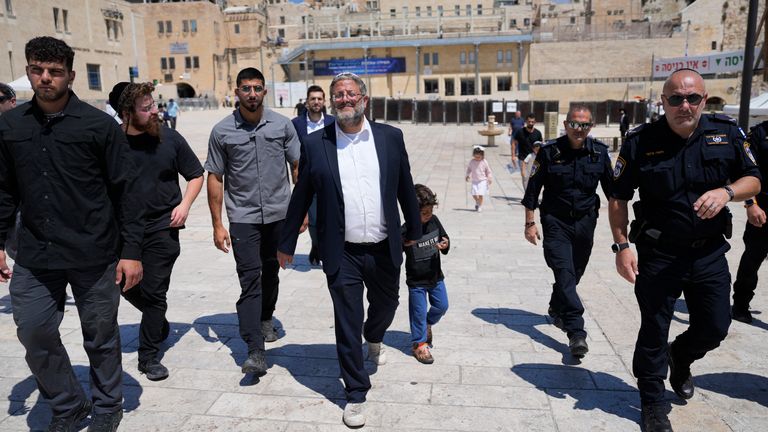 FILE - Israel's far-right National Security Minister Itamar Ben-Gvir, center, flanked by his security detail, approach the entrance to Jerusalem's most sensitive holy site in the Old City, on Aug. 13, 2024. (AP Photo/Ohad Zwigenberg, File)