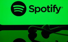 In this photo illustration a mobile phone screen displaying Spotify logo with a headset in front of it, in Ankara, Turkiye on May 01, 2024.