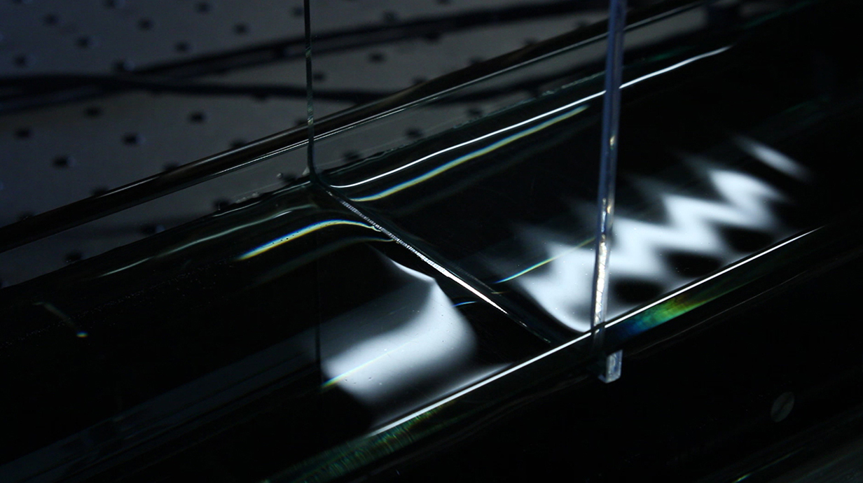 A wave ripples through a tank of water in a laboratory.