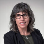 Portrait of Christine Weeks. Should length brown hair with glasses.