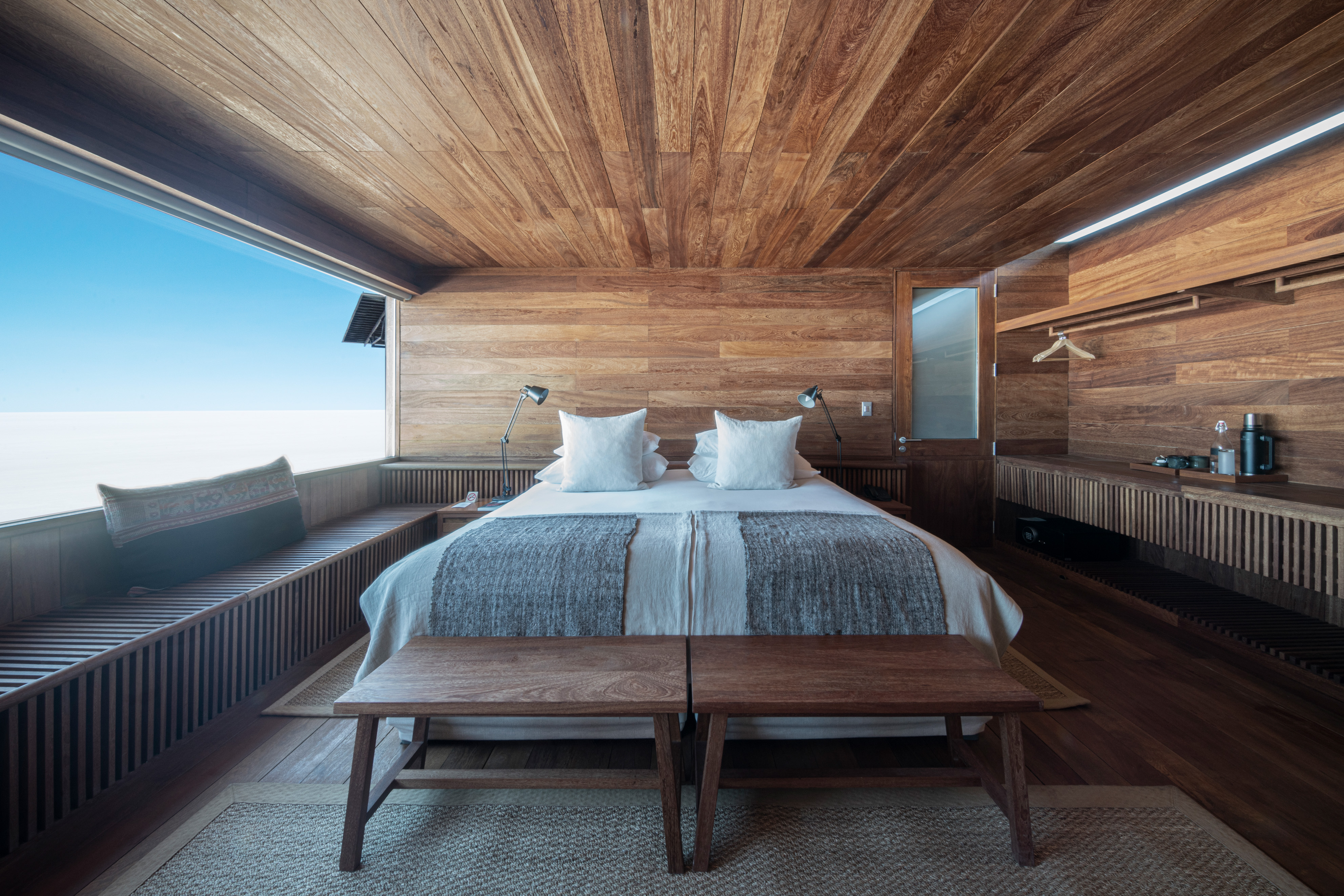 Hotel room with a wooden interior and a view.