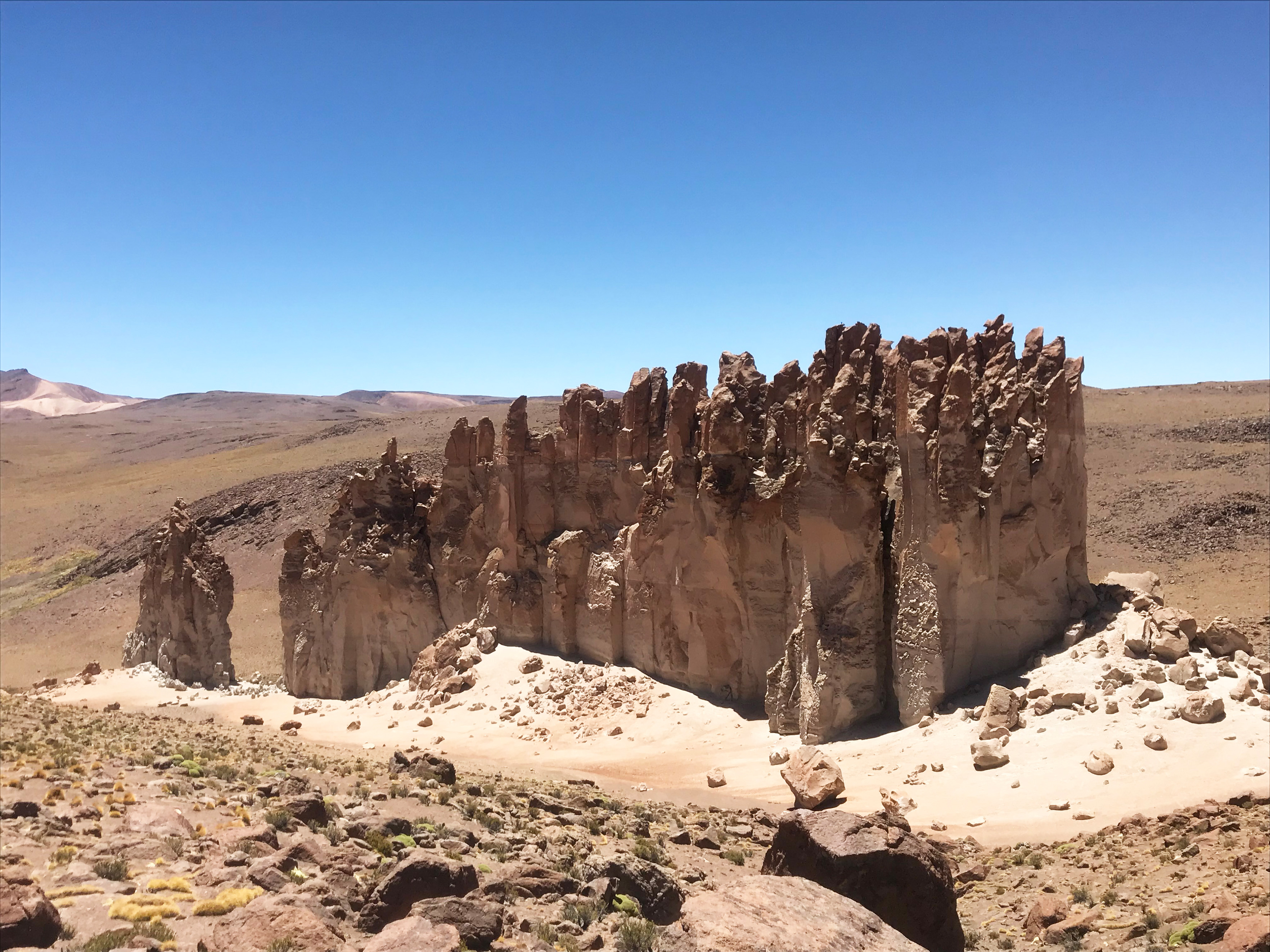 Tall rock formations in a desert landscape.