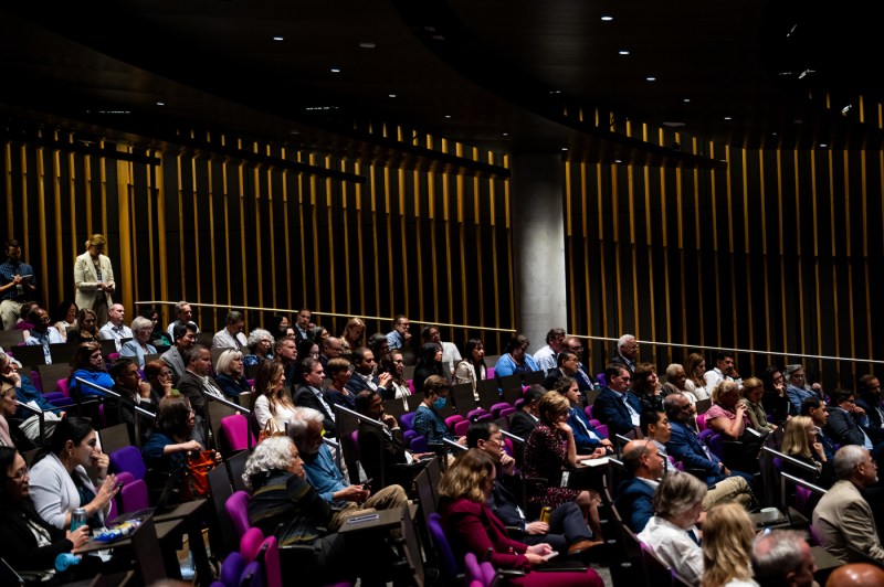 Audience members seated in the ISEC auditorium watch the fireside chat at Northeastern University’s Senior Leadership Retreat.