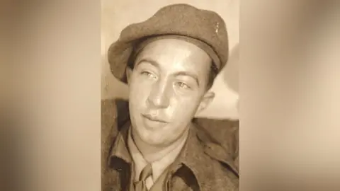 Supplied Alfonso Garizio, pictured in a sepia brown and white photo from WW2. He is wearing military uniform - jacket, shirt and tie, and a beret.
