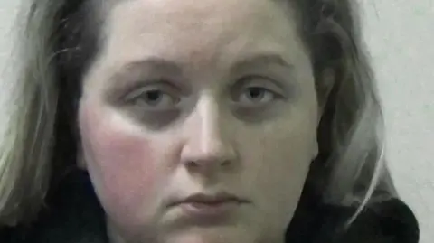 Northumbria Police Mugshot of Zoe Williams. She is staring straight at the camera and has blonde hair. She looks tired.