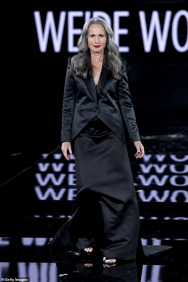 Andie MacDowell cut a glamorous figure in a black satin blazer and a matching skirt and heels