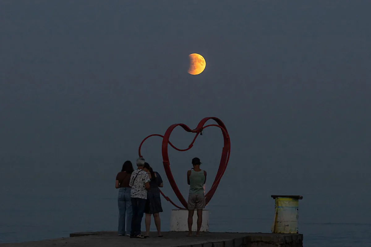 Beach-goers observe the 7 September 2025 lunar eclipse on a shore of the Black Sea, Odesa, Ukraine. Photo by OLEKSANDR GIMANOV/AFP via Getty Images