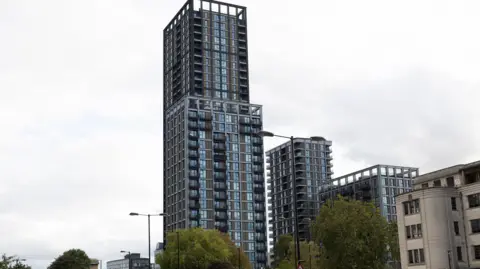Facundo Arrizabalaga The Fold is seen as a modern glass and steel tower block in Croydon with balconies, photographed from street level.
