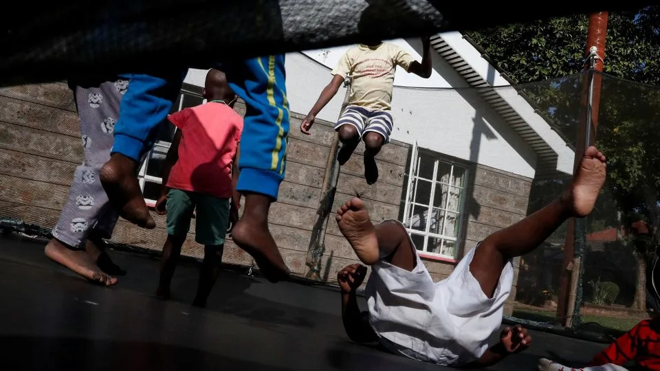 Children play on a trampoline at the Nyumbani Children's Home in Kenya, which cares for more than 100 children with HIV, whose parents died of the disease, while providing them with US-funded supplies of antiretroviral medicines. - Thomas Mukoya/Reuters
