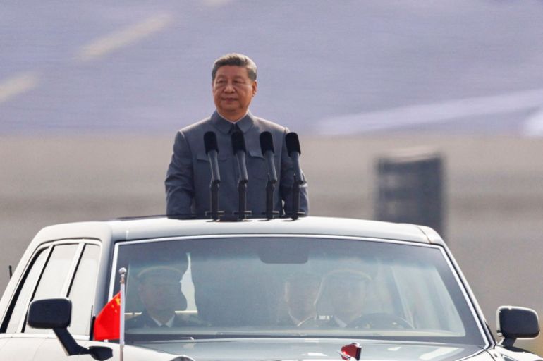 Chinese President Xi Jinping stands in a car to review the troops during a military parade to mark the 80th anniversary of the end of World War Two, in Beijing, China, September 3, 2025. REUTERS/Tingshu Wang REFILE - QUALITY REPEAT