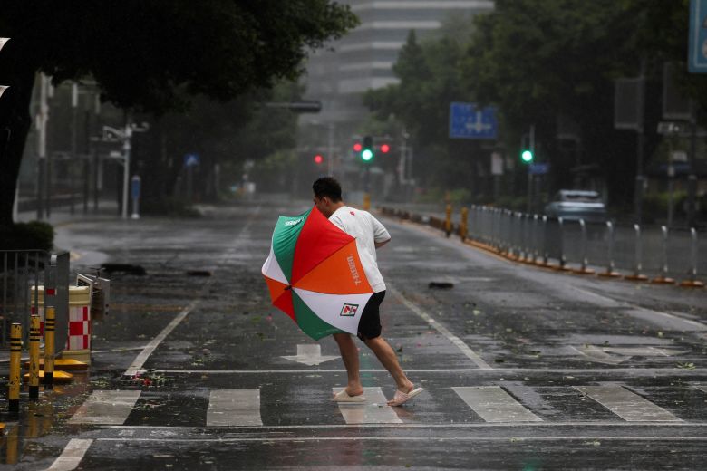 A person braves strong wind and rain as Typhoon Ragasa approaches in Shenzhen on Wednesday.