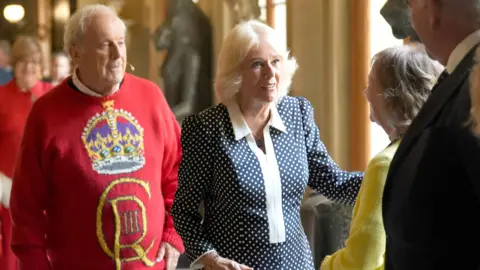 PA Media Queen Camilla with Gyles Brandreth (left) at a reception for literary figures during The Queen's Reading Room Festival at Chatsworth House.