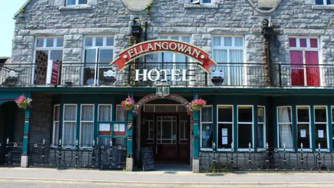Billy McCrorie A pub made of large granite blocks with a series of windows and the sign the Ellangowan Hotel above the entrance