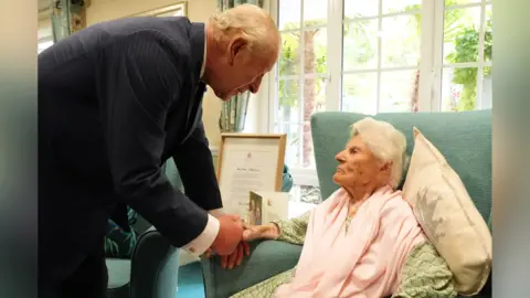 PA King Charles III meets the world's oldest person, 116-year-old Ethel Caterham, at Hallmark Lakeview Care Home in Lightwater, Surrey.
