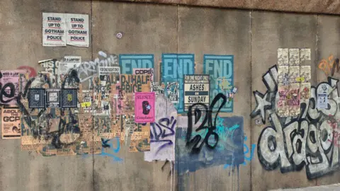 Out In Liverpool Fake graffiti and posters on the nearby walls of the court building create part of the film set