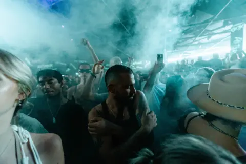 Connor Baker Smokey image of people dancing in a night club